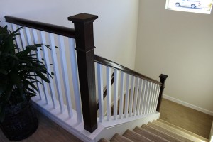 Bow newel post with stain grade handrail